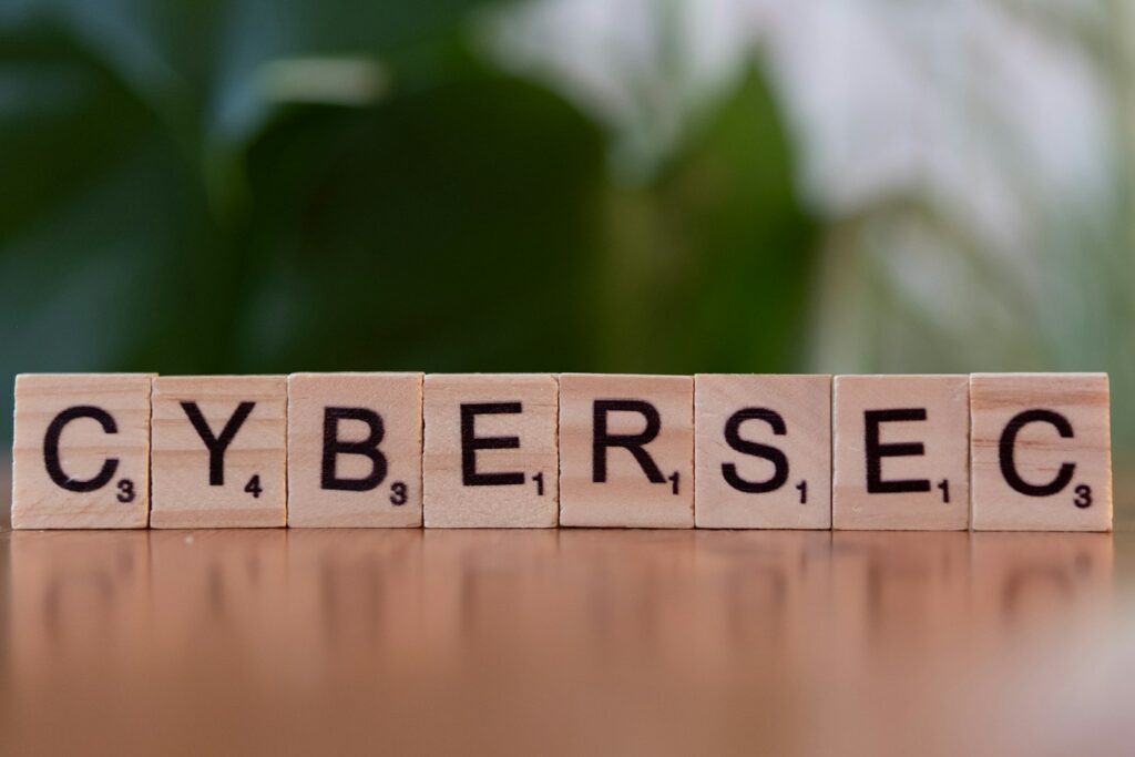 A wooden block spelling cybersec on a table